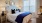 a bed with blue sheets