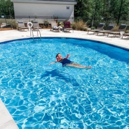 The essence of exceptional living Resort-style swimming pool with lounge seating