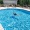 Resort-style swimming pool with lounge seating