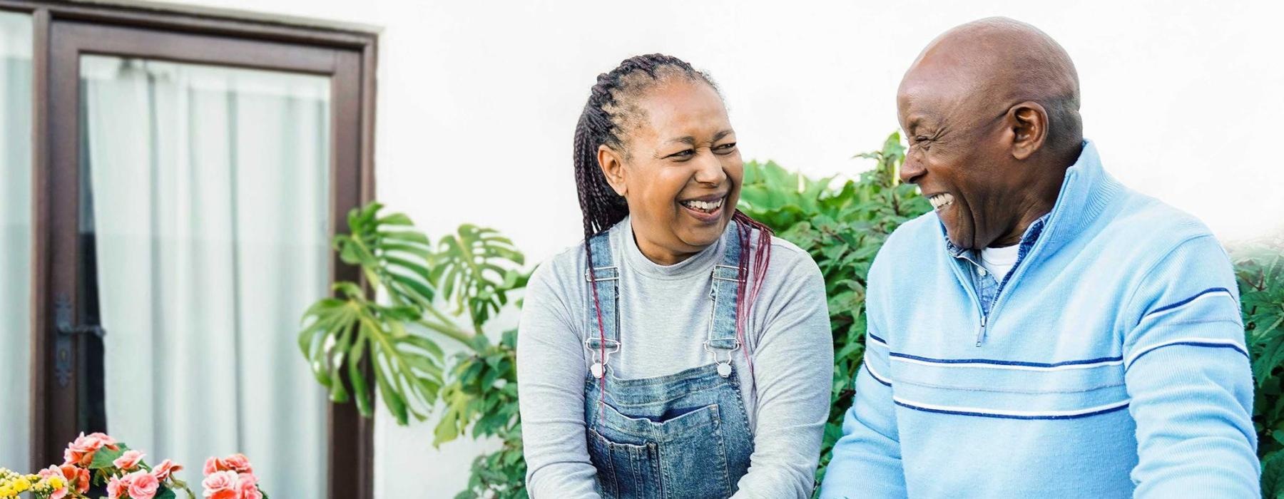 a man and a woman smiling while gardening