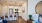 a kitchen with a dining table and a large mirror