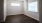 a room with a wood floor and a ceiling fan