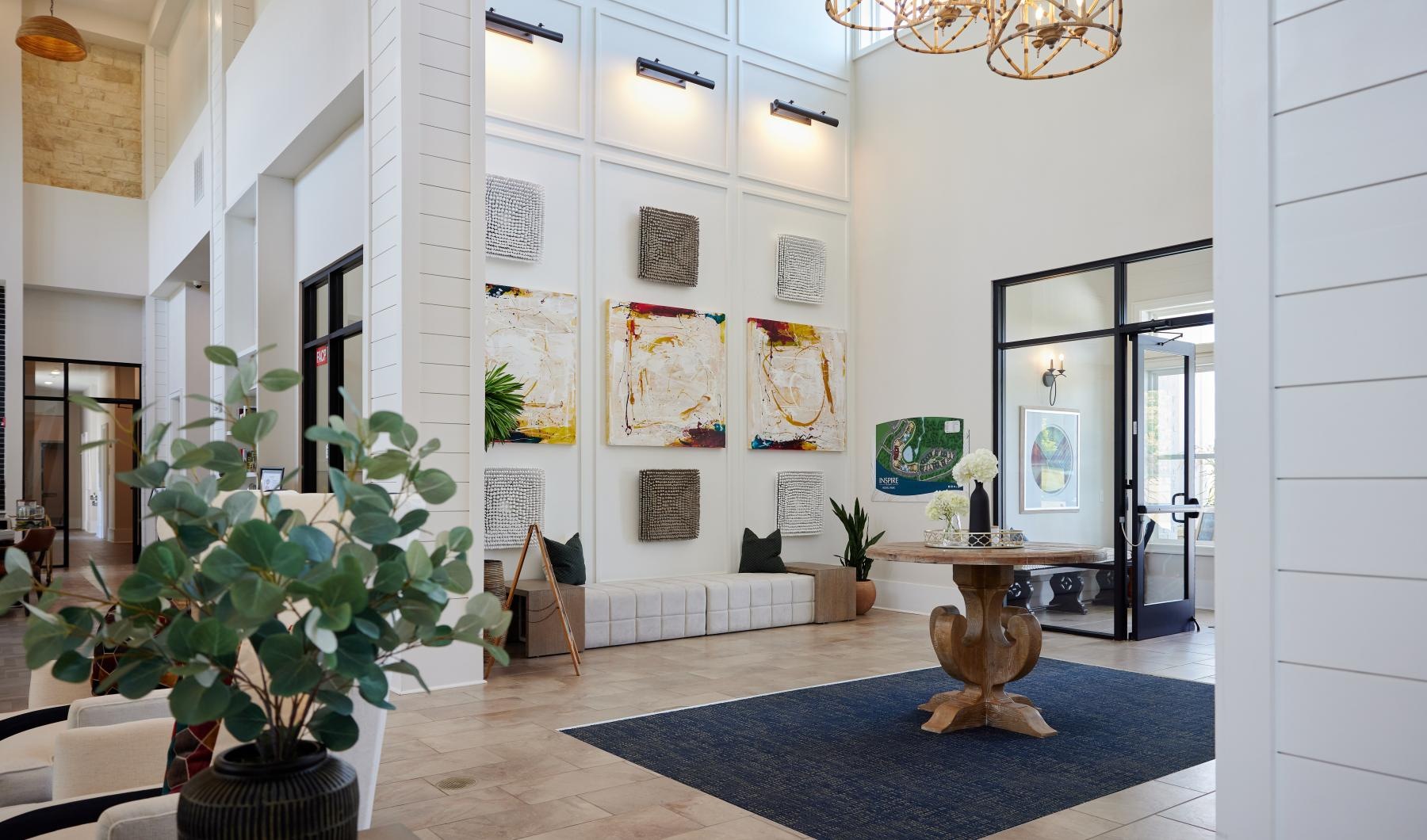 a room with a chandelier and a rug