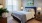 a bedroom with a bed and lamps